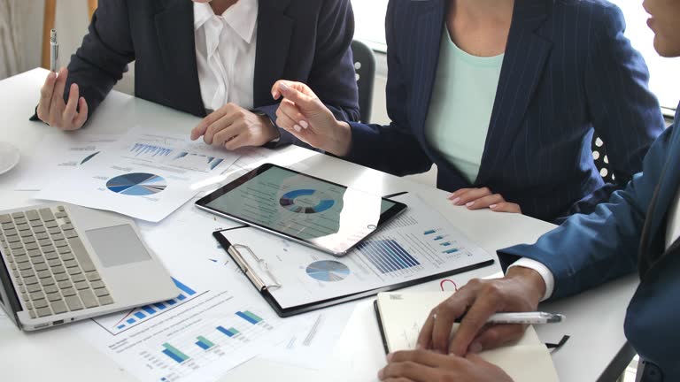 Professional reviewing strategic financial planning papers on workspace table